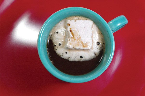 Hot beverage in a mug, with a large floating marshmallow.