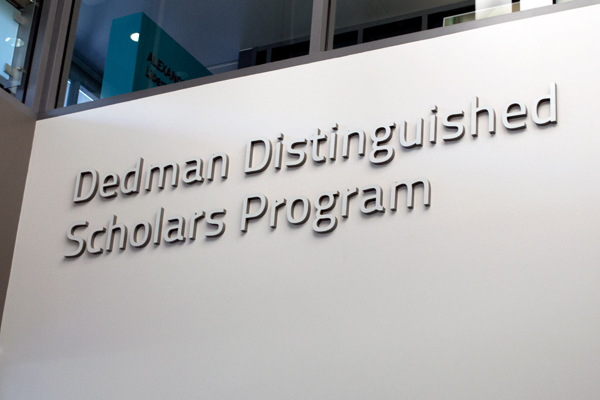 Dedman Distinguished Scholars Program signage in silver lettering located in the College of Liberal Arts Building.