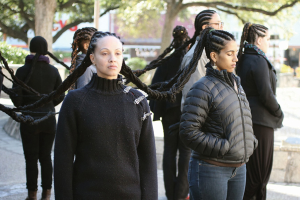 Agatha Oliverira and Natasha Mevs-Korff participate in beauty, a public endurance piece performed Nov. 13 on the West Mall. Photo: Sonsereé Verdise Gibson
