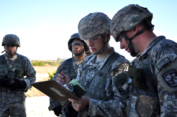 Cadets looking over plans together