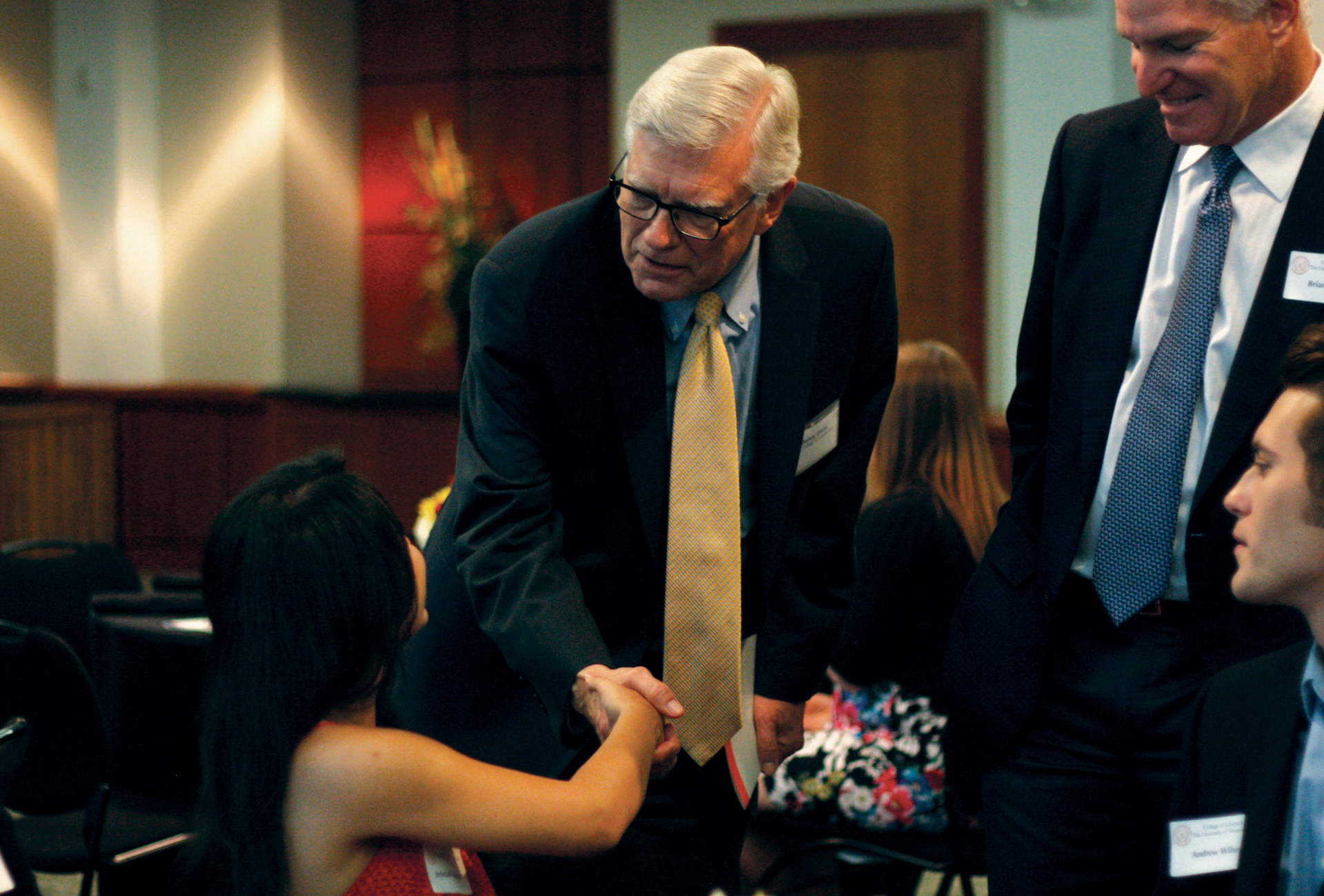 Randy Diehl greets Dean’s Distinguished Graduate Rebekah Rodriguez and her family at a luncheon on May 15, 2014.