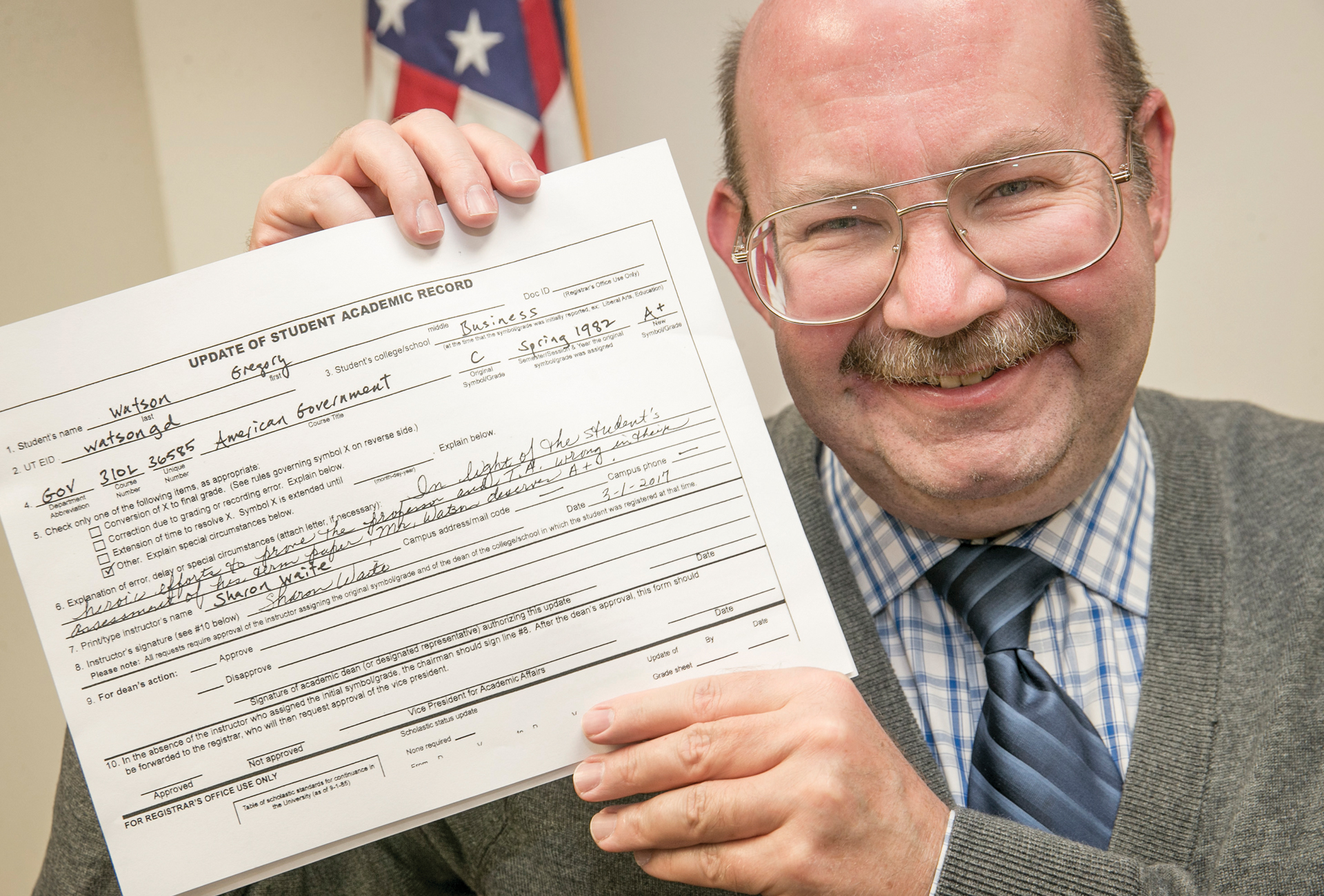 Photo of Gregory Watson shows off the A+ on his Update of Student Academic Record application at his office at the Texas Capitol.