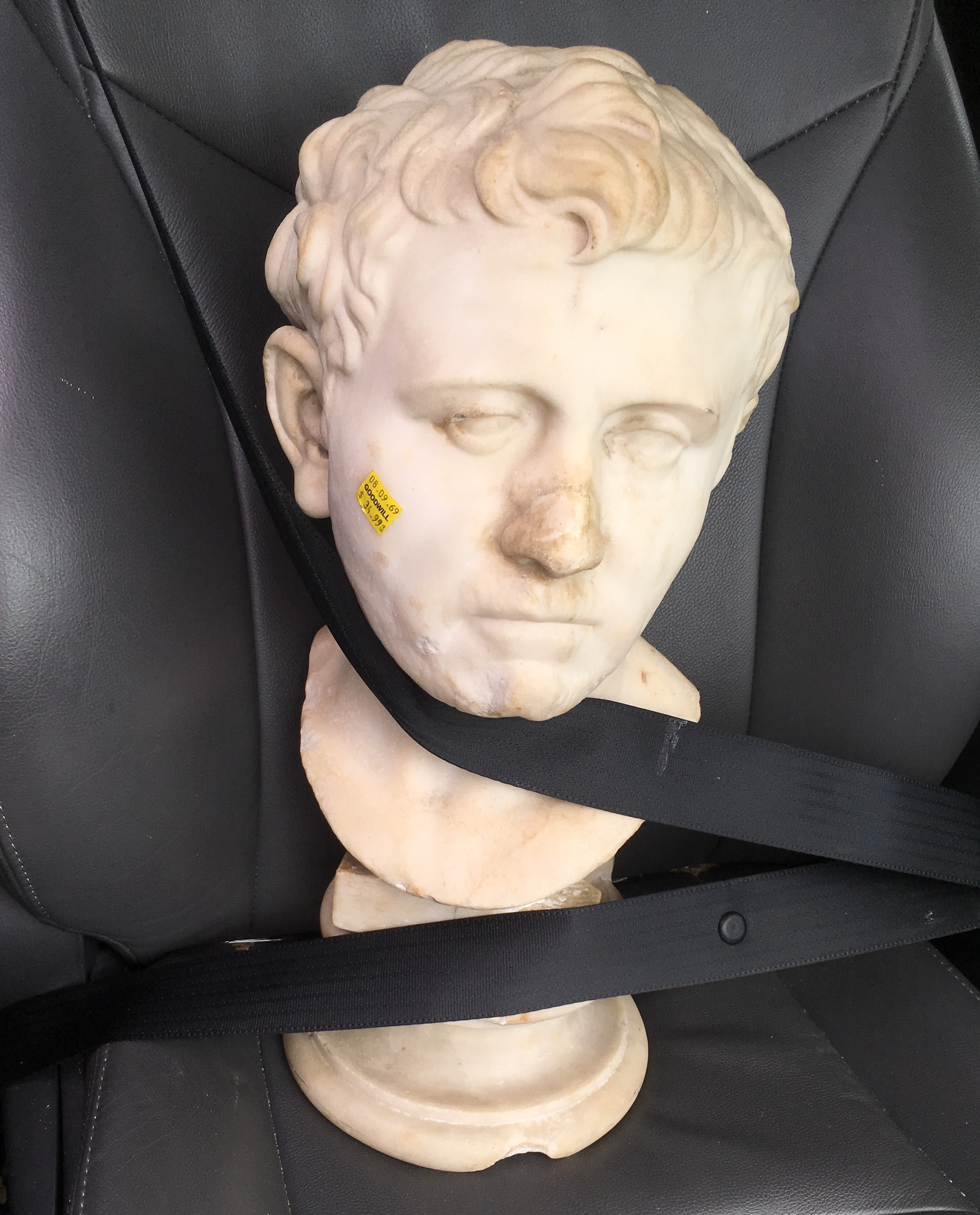 White marble ancient Roman bust found at Goodwill and brought to UT Austin experts strapped into carseat